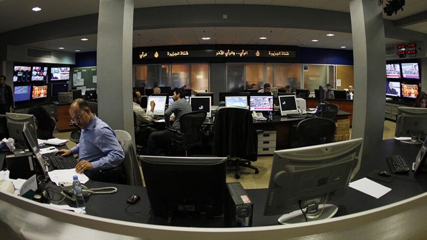 A general view shows the newsroom at the headquarters of the Qatar-based Al Jazeera satellite channel in Doha February 7, 2011. As much as CNN capitalized on its coverage of the 1990-91 Gulf War, Al Jazeera English has won praise for its on-the-spot reporting and context about the Egyptian protests. It will be talking to U.S. cable operators about deals "in the coming days and weeks," Al Anstey, managing director of Al Jazeera's English-language service said in a telephone interview from Qatar. REUTERS/ Fad