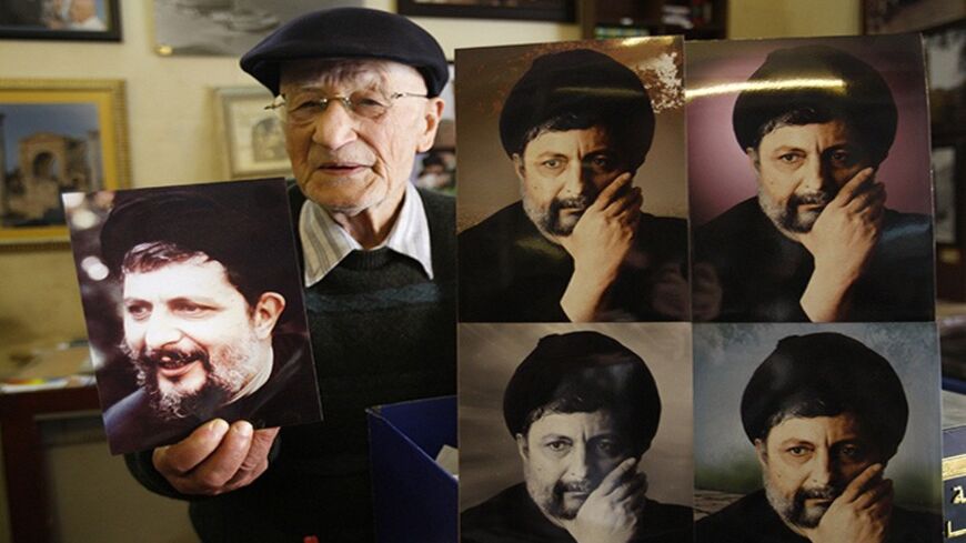 Photographer Mohamed Turjuman shows what he says are pictures that he took of Imam Musa al-Sadr, at his studio in Tyre, southern Lebanon, February 23, 2011. Sadr, the founder of the Shi'ite Amal movement, disappeared with his two companions on a visit to Libya in 1978. The uprising against Muammar Gaddafi has given Sadr's family hope that they may finally find out what happened to him if the Libyan leader is toppled, Rabab al-Sadr told Reuters on February 24, 2011. Picture taken February 23, 2011. REUTERS/ 