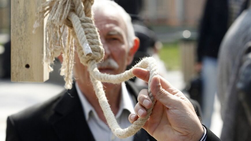 A Turkish supporter of capital punishment holds a hanging rope as activists launch a petition campaign for its reinstitution in Ankara March 29, 2011. Public debate on the issue has been revived following a number of sexually motivated murders recently committed in the country which abolished the death penalty on January 15, 2003. The group also protests the reprieve given to Abdullah Ocalan, the jailed leader of the separatist Kurdish Workers Party (PKK) whose death penalty  was approved by the appeals cou