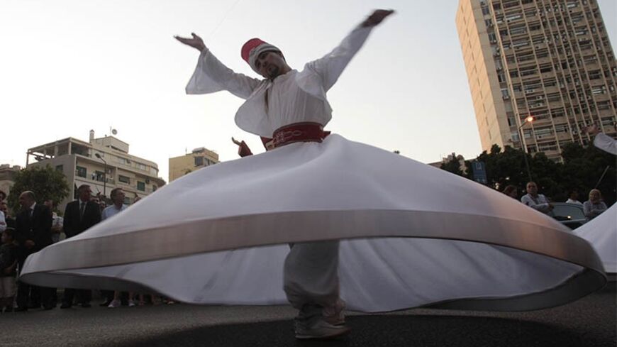 A Darawish Sufi dancer performs a traditional dance to celebrate the beginning of the holy month of Ramadan during the Ajyalouna Festival in Beirut July 30, 2011. Muslims around the world abstain from eating, drinking and conducting sexual relations from sunrise to sunset during Ramadan, the holiest month in the Islamic calendar. REUTERS/Jamal Saidi (LEBANON - Tags: RELIGION SOCIETY) - RTR2PH1I