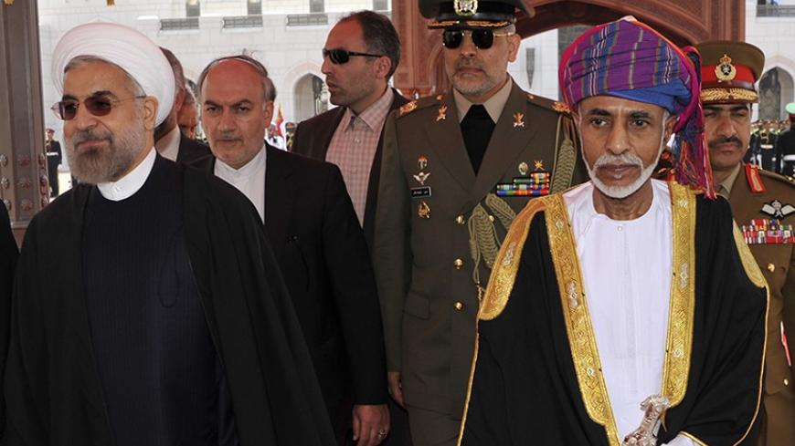 Oman's Sultan Qaboos bin Said (R) walks with Iran's President Hassan Rouhani upon Rouhani's arrival in Muscat March 12, 2014. REUTERS/Sultan Al Hasani (OMAN - Tags: POLITICS ROYALS) - RTR3GQAH