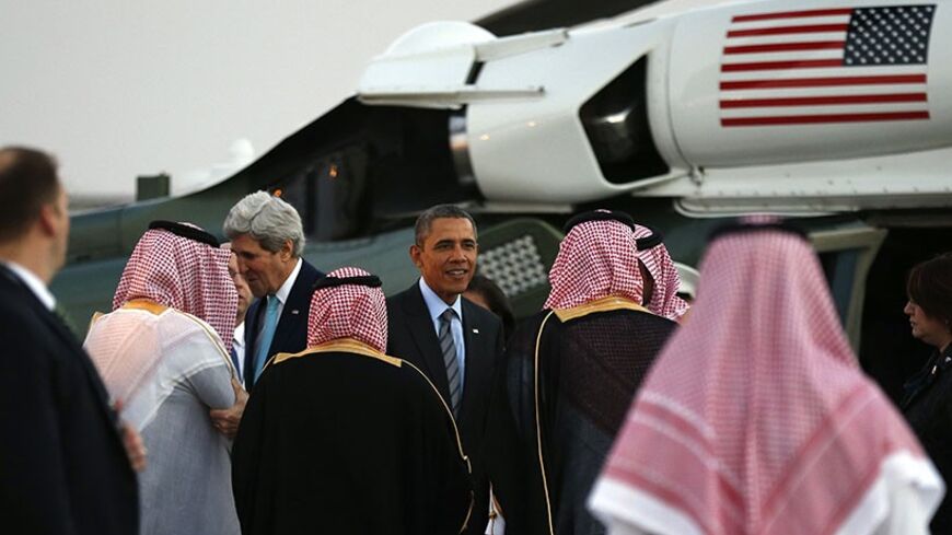 U.S. Secretary of State John Kerry (L) and U.S. President Barack Obama are greeted upon their arrival on Marine One for a meeting with Saudi King Abdullah at Rawdat al-Khraim (Desert Camp) near Riyadh in Saudi Arabia, March 28, 2014.  
REUTERS/Kevin Lamarque  (SAUDI ARABIA - Tags: POLITICS) - RTR3J176