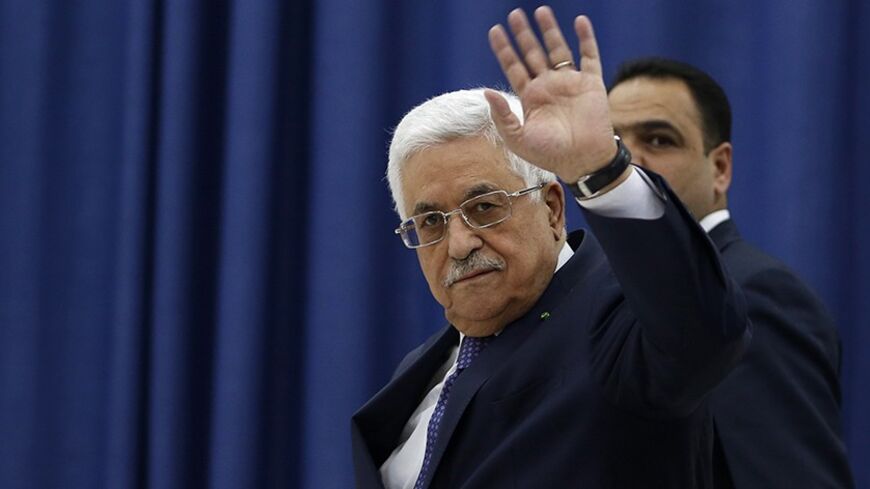 Palestinian President Mahmoud Abbas waves as he arrives to a meeting of the Palestinian leadership in the West Bank city of Ramallah March 31, 2014.  U.S. Secretary of State John Kerry broke from his travel schedule for the second time in a week and rushed back to the Middle East on Monday to try to salvage Israeli-Palestinian peace talks. A major stumbling block is Israeli Prime Minister Benjamin Netanyahu's demand that Abbas explicitly recognise Israel as a Jewish state. REUTERS/Mohamad Torokman (WEST BAN
