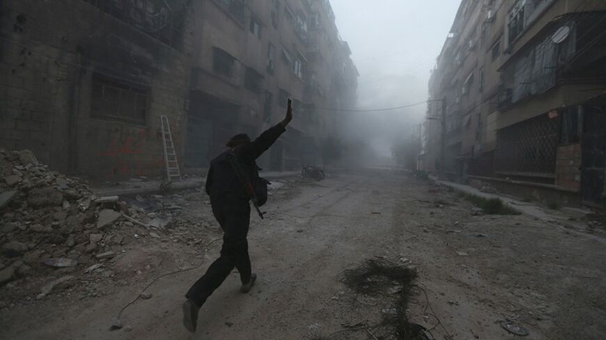 A rebel fighter gestures as he runs across a street in Mleha suburb of Damascus, during what the rebel fighters said was an offensive against them by forces loyal to Syria's President Bashar al-Assad, April 2, 2014. REUTERS/Bassam Khabieh   (SYRIA - Tags: POLITICS CIVIL UNREST CONFLICT TPX IMAGES OF THE DAY) - RTR3JQRF