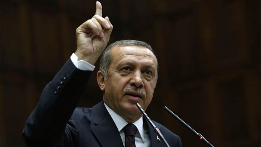 Turkey's Prime Minister Tayyip Erdogan addresses members of parliament from his ruling AK Party (AKP) during a meeting at the Turkish parliament in Ankara April 8, 2014. Turkey's first directly elected president will be a more powerful figure than the current largely ceremonial role, Prime Minister Tayyip Erdogan was quoted on Tuesday as saying, boosting expectations he may run for the post in August. Erdogan is barred by the rules of his ruling AK Party from standing for a fourth term as prime minister and