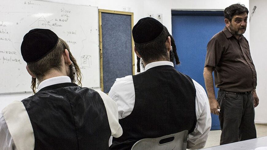 Ultra-Orthodox Jewish men attend an English lesson in Elad, an ultra-Orthodox town near Tel Aviv, October 17, 2013. Adhering to a strict religious lifestyle, Haredim - Hebrew for "those who fear God" - mostly live in their own towns and neighbourhoods, keep to their own schools and shun secular culture. But there are signs of a growing, dispersed movement driving change inside the cloistered, and also poor, community. Picture taken October 17, 2013. REUTERS/Nir Elias (ISRAEL - Tags: POLITICS EDUCATION SOCIE