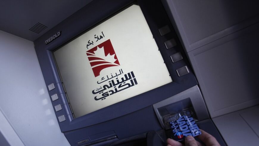 A man uses an ATM at the Lebanese Canadian Bank (LCB) headquarters in Beirut February 11, 2011. Lebanon's central bank governor Riad Salameh expressed support on Friday for Beirut-based Lebanese Canadian Bank (LCB), which faces U.S. Treasury Department accusations of involvement in money laundering. REUTERS/ Cynthia karam    (LEBANON - Tags: BUSINESS) - RTXXQK2