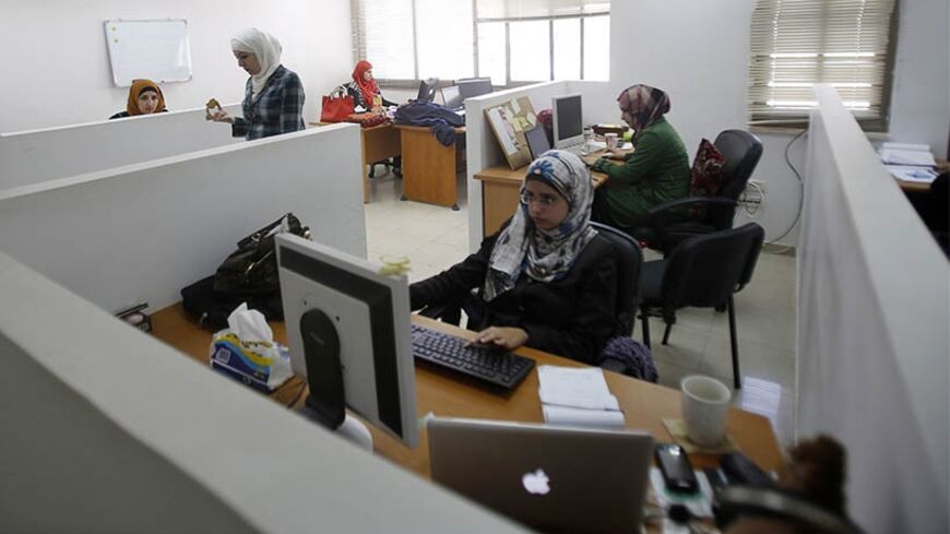 Employees work on computers at Exalt Technologies, a company which deals in research and development outsourcing from Cisco and French-American group Lucent-Alcatel, in the West Bank city of Ramallah April 7, 2013.  Fledgling Palestinian high-tech firms hope they can now help revitalise the economy, making the West Bank more resistant to Israeli controls on land and the movement of goods and people and less dependent on fickle foreign aid flows, which are blighting the public sector. Picture taken April 7, 