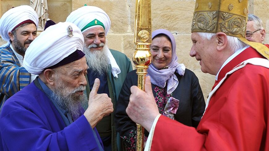 In this handout picture released by the Vatican press office, Pope Benedict XVI meets with Sufi mystic Sheikh Nazim Haqqani (L), who travelled from the north of the divided island of Cyprus, to see him at the Latin Church of the Holy Cross in Nicosia on June 5, 2010, the second day of the pontiff's visit to the mainly Greek Orthodox east Mediterranean island.  AFP PHOTO / POOL / OSSERVATORE ROMANO  -- RESTRICTED TO EDITORIAL USE -- (Photo credit should read --/AFP/Getty Images)