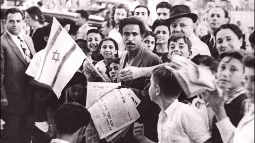 TEL-AVIV, ISRAEL:  The crowd of Jews assembled in the streets of Tel Aviv 20 May 1948 a few hours before the British Mandate in Palestine ended, celebrate the proclamation of a new Jewish state of Israel. Israel was founded on 14 May 1948 by the Jewish National Council and was recognized by the United States and the Soviet Union 15 and 17 May. (Photo credit should read AFP/Getty Images)