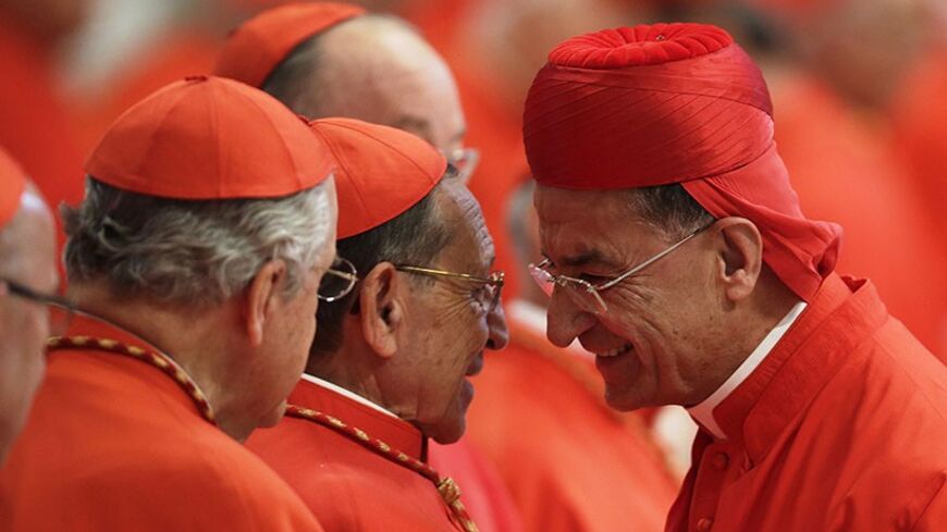 New Cardinal Bechara Boutros Rai of Lebanon (R) is congratulated by an unidentified cardinal during a consistory ceremony in Saint Peter's Basilica at the Vatican November 24, 2012. Pope Benedict XVI installed 6 new Roman Catholic cardinals from around the world on Saturday. REUTERS/Tony Gentile (VATICAN - Tags: RELIGION) - RTR3ATCU