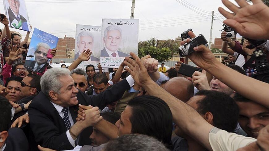 Egypt's leftist presidential candidate Hamdeen Sabahi (L) greets supporters before a rally in Banha, northwest of Cairo May 7, 2014. Egyptians will vote in presidential elections on May 26 and 27.  REUTERS/Mohamed Abd El Ghany (EGYPT - Tags: POLITICS ELECTIONS) - RTR3O77Z