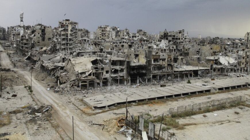 Destroyed buildings are pictured, after the cessation of fighting between rebels and forces loyal to Syria's President Bashar al-Assad, in Homs city, May 10, 2014. Picture taken May 10, 2014. REUTERS/Ghassan Najjar (SYRIA - Tags: CIVIL UNREST CONFLICT) - RTR3ON0N