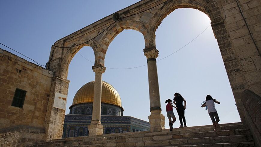 Palestinian girls walk up stairs near the Dome of the Rock (L) on a compound revered by Jews as the Temple Mount and by Muslims as the Noble Sanctuary, in Jerusalem's Old City June 23, 2013. Far-right Israelis have stepped up efforts to hold Jewish prayers at the Jerusalem holy compound once dominated by Biblical temples and now home to al-Aqsa mosque, one of Islam's most revered sites. Picture taken June 23, 2013. REUTERS/Darren Whiteside (JERUSALEM - Tags: RELIGION CIVIL UNREST) - RTX10ZBH