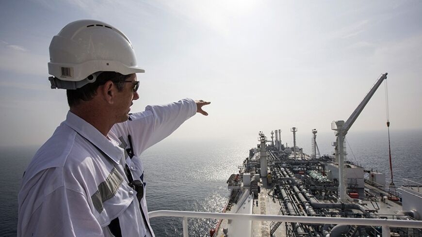 An officer points as he stands on a tanker carrying liquefied natural gas in the Mediterranean, some 10 km (6 miles) from the coastal Israeli city of Hadera January 22, 2014. Permanently anchored in the choppy waters of the eastern Mediterranean, the tanker Excellence is in a constant state of alert, waiting for the emergency phone call that Israel needs fuel. The gas, imported and stored in liquid form on the tanker, can be "regassified" and pumped through a special buoy into an underwater pipeline, provid