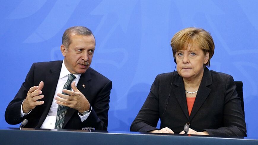 German Chancellor Angela Merkel and Turkey's Prime Minister Tayyip Erdogan address the media after talks in Berlin February 4, 2014. REUTERS/Tobias Schwarz  (GERMANY - Tags: POLITICS) - RTX187HG