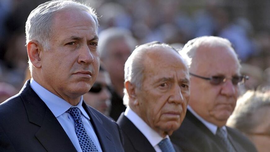Israel's President Shimon Peres (C), Prime Minister Benjamin Netanyahu (L) and Reuven Rivlin, speaker of the Parliament, attend a ceremony marking Jerusalem Day at Ammunition Hill in Jerusalem May 21, 2009. Jerusalem Day marks the anniversary of Israel's capture of the Arab Eastern part of the city. Israel annexed East Jerusalem as part of its capital in the 1967 Middle East War in a move not recognized internationally. Netanyahu said on Thursday that Jerusalem would "never be divided" and would remain the 