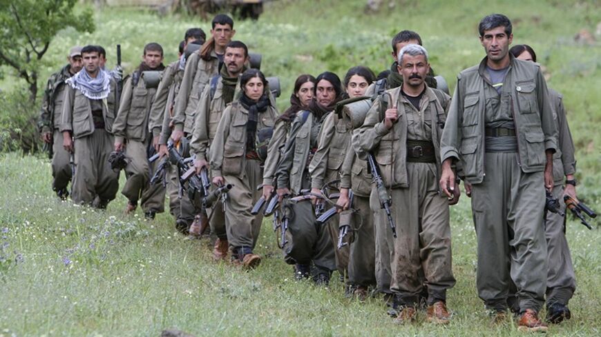 Kurdistan Workers Party (PKK) fighters walk on the way to their new base in northern Iraq May 14, 2013. The first group of Kurdish militants to withdraw from Turkey under a peace process entered northern Iraq on Tuesday, and were greeted by comrades from the Kurdistan Workers Party (PKK), in a symbolic step towards ending a three-decades-old insurgency. The 13 men and women, carrying guns and with rucksacks on their backs, arrived in the area of Heror, near Metina mountain on the Turkish-Iraqi border, a Reu