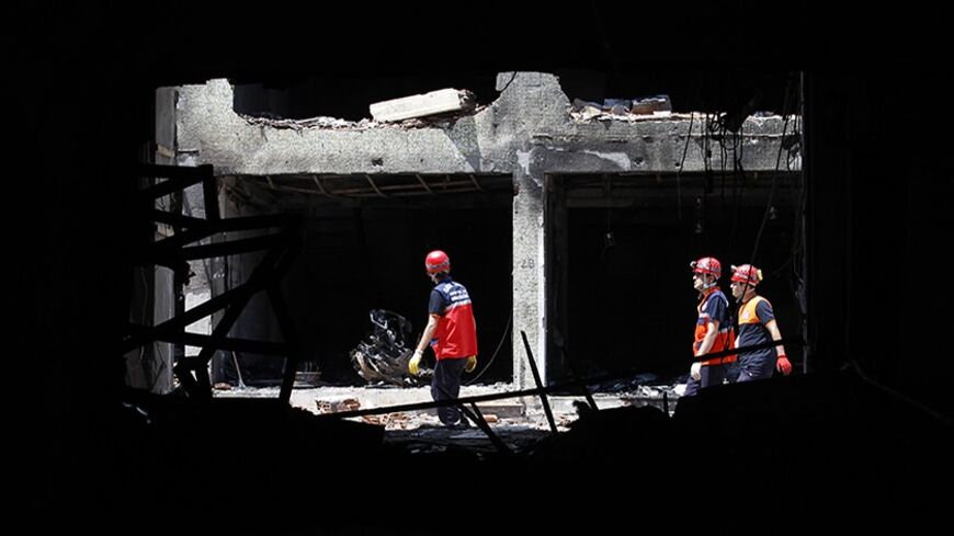 Search and rescue officers work at a damaged building at the site of blast in the town of Reyhanli in Hatay province, near the Turkish-Syrian border, May 14, 2013. REUTERS/Umit Bektas (TURKEY - Tags: POLITICS CIVIL UNREST) - RTXZLWH
