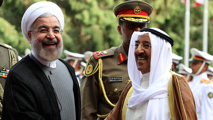 Iranian President Hassan Rouhani (L) greets Emir of Kuwait, Sheikh Sabah al-Ahmad al-Sabah (R) upon his arrival in Tehran on June 1, 2014. Kuwait's Emir started a landmark visit to Tehran focused on mending fences between Shiite Iran and the Sunni-ruled monarchies in the Gulf. AFP PHOTO/ATTA KENARE        (Photo credit should read ATTA KENARE/AFP/Getty Images)