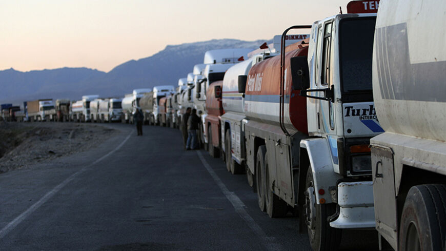 Turkish trucks and tankers, shuttling between Turkey and Iraq, queue on a road leading to the Habur border gate in southeastern Turkey, before crossing into Iraq with their goods, February 23, 2008. Turkey's exports to Iraq jumped nine percent last year to $2.8 billion and its influence can be felt across northern Iraq in the form of supermarkets, consumer goods, construction firms and traders from all over Turkey. To match feature TURKEY-IRAQ/CONFLICT REUTERS/Fatih Saribas  (TURKEY)  REUTERS/Fatih Saribas 