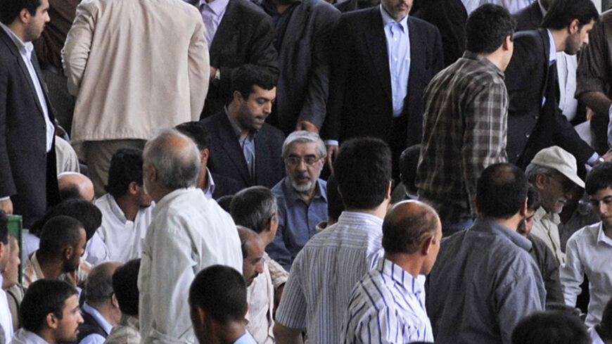 EDITORS' NOTE: Reuters and other foreign media are subject to Iranian restrictions on their ability to film or take pictures in Tehran.

Iran's opposition leader and former presidential candidate Mirhossein Mousavi (C) attends Friday prayers in Tehran July 17, 2009. QUALITY FROM SOURCE. REUTERS/ISNA (IRAN POLITICS RELIGION) - RTR25RB8
