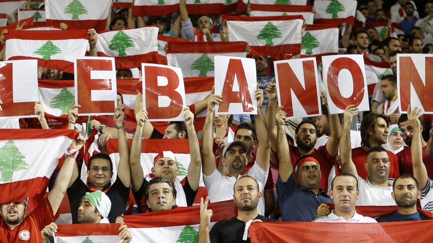 Fans of Lebanon cheer their team during their 2014 World Cup qualifying soccer match against Qatar in Doha, November 14, 2012. REUTERS/Fadi Al-Assaad  (QATAR - Tags: SPORT SOCCER) - RTR3AEDG