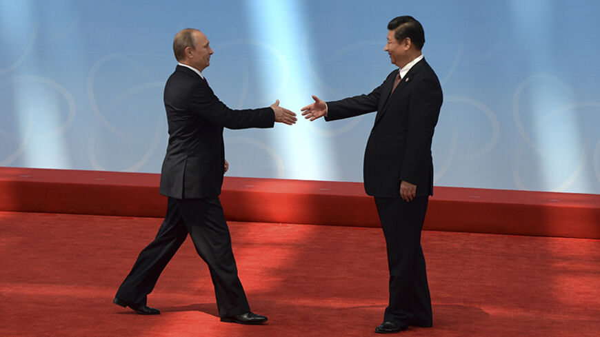 Russia's President Vladimir Putin (L) is greeted by his Chinese counterpart Xi Jinping before the opening ceremony of the fourth Conference on Interaction and Confidence Building Measures in Asia (CICA) summit in Shanghai May 21, 2014. REUTERS/Mark Ralston/Pool (CHINA - Tags: POLITICS) - RTR3Q3LZ