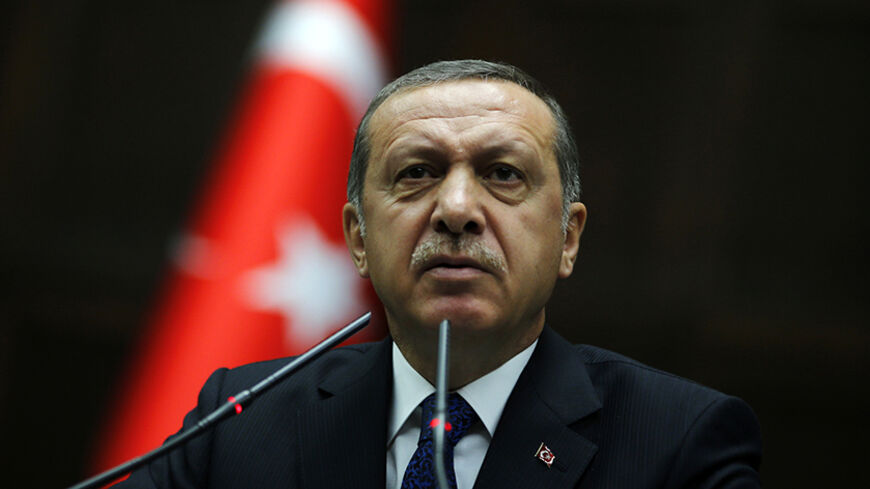 Turkey's Prime Minister Tayyip Erdogan addresses members of parliament from his ruling AK Party (AKP) during a meeting at the Turkish parliament in Ankara June 3, 2014. Erdogan, who has criticised the central bank for not cutting interest rates enough, said he did not accept Governor Erdem Basci's approach on rates and hoped the bank would act immediately to resolve the issue. Speaking to reporters a day after Basci briefed the cabinet on central bank policy, Erdogan said the latest data showed that inflati