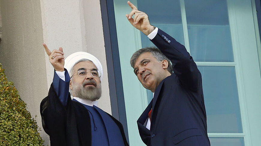 Turkey's President Abdullah Gul (R) and his Iranian counterpart Hassan Rouhani speak on a balcony of the Presidential Palace of Cankaya in Ankara June 9, 2014. REUTERS/Umit Bektas (TURKEY - Tags: POLITICS) - RTR3SUCC