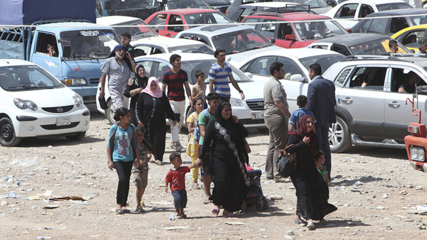 Families fleeing the violence in the Iraqi city of Mosul arrive at a checkpoint in outskirts of Arbil, in Iraq's Kurdistan region, June 10, 2014.  Radical Sunni Muslim insurgents seized control of most of Iraq's second largest city of Mosul early on Tuesday, overrunning a military base and freeing hundreds of prisoners in a spectacular strike against the Shi'ite-led Iraqi government. REUTERS/Azad Lashkari (IRAQ - Tags: CIVIL UNREST POLITICS MILITARY) - RTR3T260