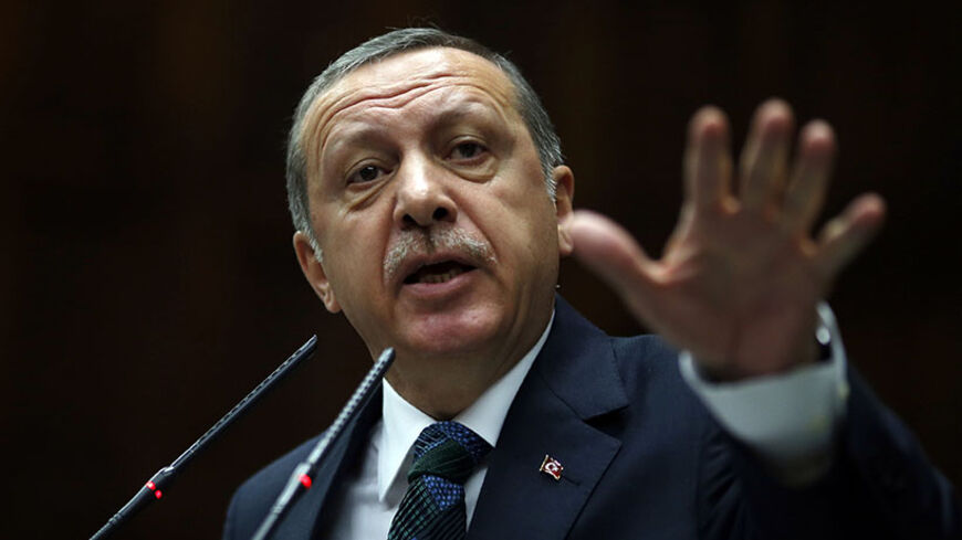 Turkey's Prime Minister Tayyip Erdogan addresses members of parliament from his ruling AK Party (AKP) during a meeting at the Turkish parliament in Ankara June 17, 2014. REUTERS/Umit Bektas (TURKEY - Tags: POLITICS HEADSHOT) - RTR3U7QA