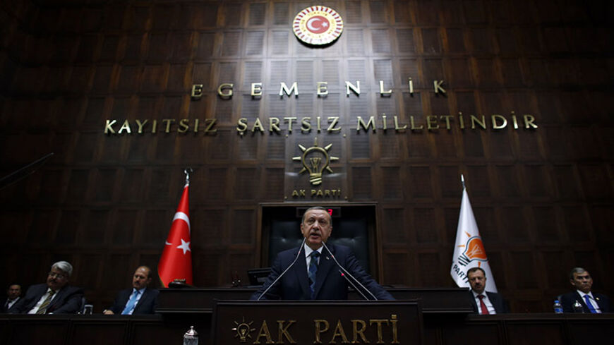 Turkey's Prime Minister Tayyip Erdogan addresses members of parliament from his ruling AK Party (AKP) during a meeting at the Turkish parliament in Ankara June 17, 2014. REUTERS/Umit Bektas (TURKEY - Tags: POLITICS) - RTR3U7T5