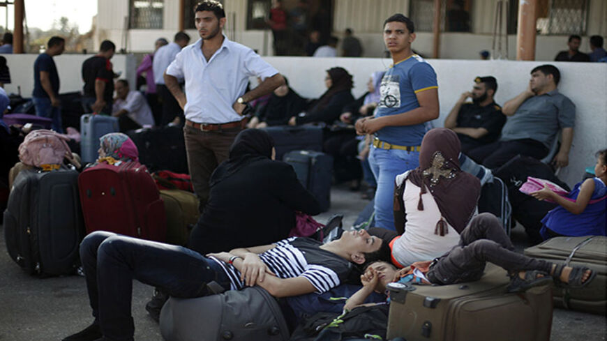 Palestinian youths take a nap as they wait with other passengers to cross into Egypt at Rafah border crossing in the southern Gaza Strip August 12, 2013. Egypt has sharply cut the number of Palestinians allowed to enter from the Gaza Strip since its military ousted Islamist president Mohamed Mursi last month, the tiny enclave's Islamist Hamas rulers said on Monday. An Egyptian official said the curbs were "not a punishment" for Hamas's Islamist leanings but an effort to reduce civilian traffic as Egypt has 