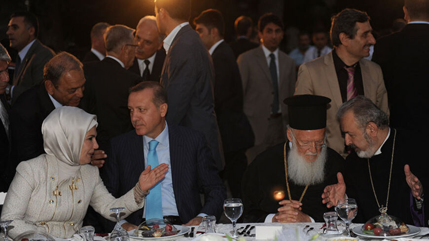 Turkish Prime Minister Recep Tayyib Erdogan`s wife Emine Erdogan (L), Recep Tayyip Erdogan (2nd L), Ecumenical Patriarch Bartholomew (C), Armenian Orthodox Archbishop Aram Atesyan (R) talk during a dinner on August 28, 2011, at the Archeology Museum Garden in Istanbul. Erdogan hosted religious leaders and the heads of about 160 minority trusts at a fast-breaking dinner for Ramadan. AFP PHOTO/BULENT KILIC (Photo credit should read BULENT KILIC/AFP/Getty Images)