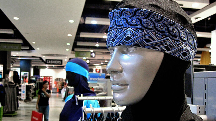 The Islamic full-length swimming suit known as Burqini is displayed on mannequins at a sports store in Dubai on August 23, 2009. The three-piece lycra and polyester bodysuit that covers all of the body and the hair is sold for 419 Dirhams (80 Euros) (114 USD). A French woman who converted to Islam, was kicked out from a Paris swimming pool earlier this month for wearing the Burqini she bought during a trip to Dubai. AFP PHOTO/MARWAN NAAMANI (Photo credit should read MARWAN NAAMANI/AFP/Getty Images)