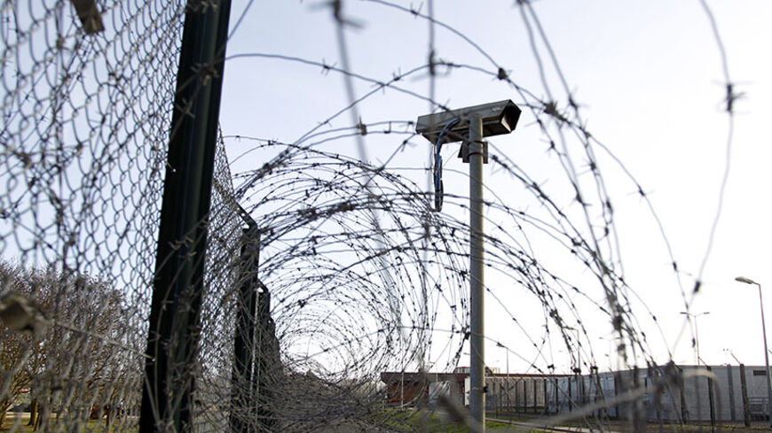 A surveillance camera is seen near a barbed-wire fence inside the Chinon Nuclear Power Plant in Chinon, centre France, January 6, 2012. France will take new measures to tighten security around its 58 nuclear power plants, Interior Minister told daily Le Parisien on Friday, after Greanpeace activists succeeded in entering two of them last month.   REUTERS/Charles Platiau  (FRANCE - Tags: ENERGY) - RTR2VYIR