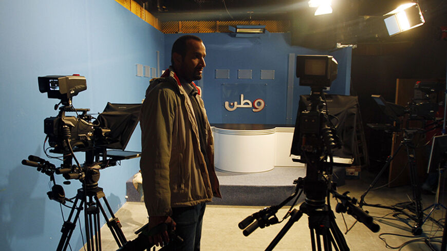 Ibraheem Hamed, a Palestinian television cameraman from Watan TV, stands in the station's studio in the West Bank city of Ramallah February 29, 2012. Israeli soldiers raided two Palestinian television stations, including Watan TV, in the occupied West Bank on Wednesday, seizing transmitters the military said were interfering with air traffic communications. The Israeli military said Watan TV and Alquds educational television, which is also based in Ramallah, had been asked repeatedly by Israel to stop using