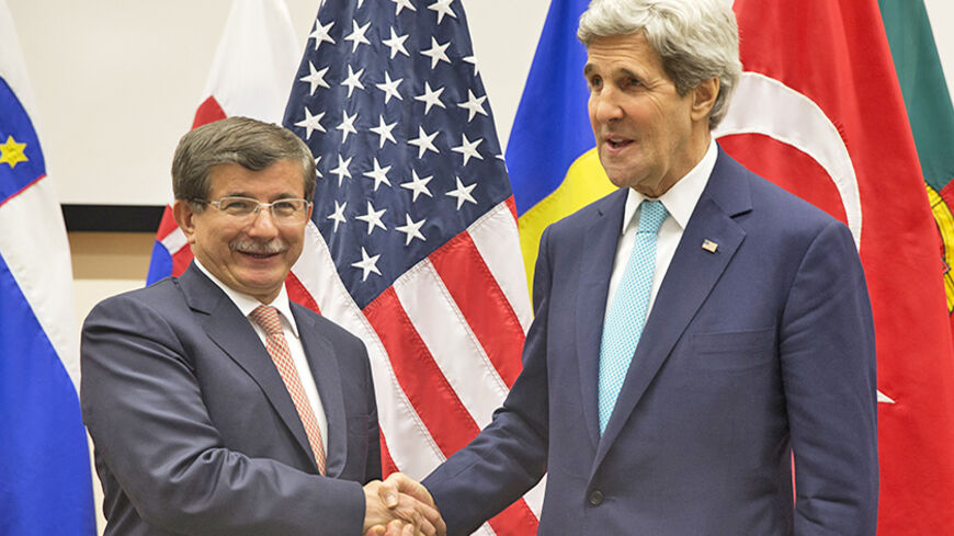 U.S. Secretary of State John Kerry shakes hands with Turkey's Foreign Minister Ahmet Davutoglu (L) during a meeting at NATO headquarters in Brussels April 1, 2014. NATO suspended all practical cooperation with Russia on Tuesday in protest at its annexation of Crimea and ordered military planners to draft measures to strengthen its defences and reassure nervous eastern European countries. REUTERS/Jacquelyn Martin/Pool (BELGIUM - Tags: POLITICS MILITARY) - RTR3JIH0