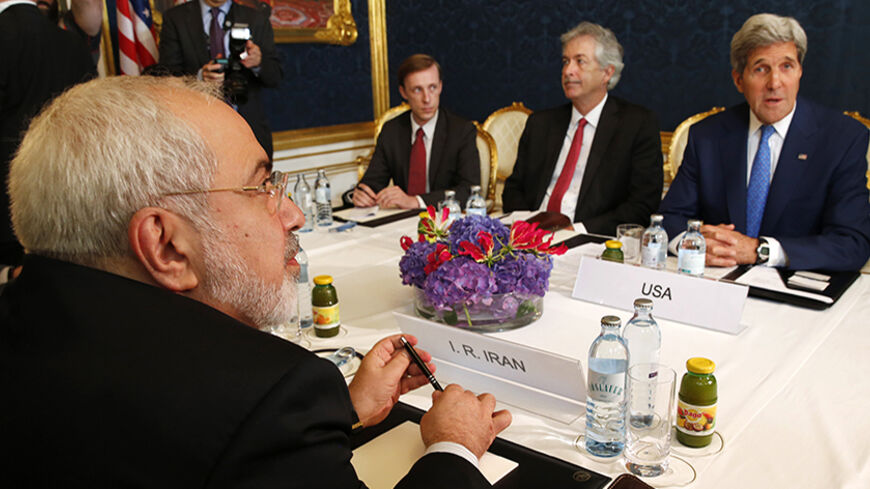 Iran's Foreign Minister Javad Zarif (L) holds a bilateral meeting with U.S. Secretary of State John Kerry (R) on the second straight day of talks over Tehran's nuclear program in Vienna, July 14, 2014. Kerry will press his Iranian counterpart Zarif to make "critical choices" in a second straight day of talks over Tehran's nuclear program on Monday, a U.S. official said.  REUTERS/Jim Bourg (AUSTRIA - Tags: POLITICS ENERGY) - RTR3YJOX