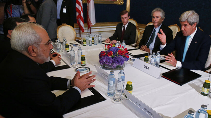 Iran's Foreign Minister Mohammad Javad Zarif (L) meets with U.S. Secretary of State John Kerry (R) at talks between the foreign ministers of the six powers negotiating with Tehran on its nuclear program in Vienna, July 13, 2014.  REUTERS/Jim Bourg    (AUSTRIA - Tags: POLITICS) - RTR3YE8T
