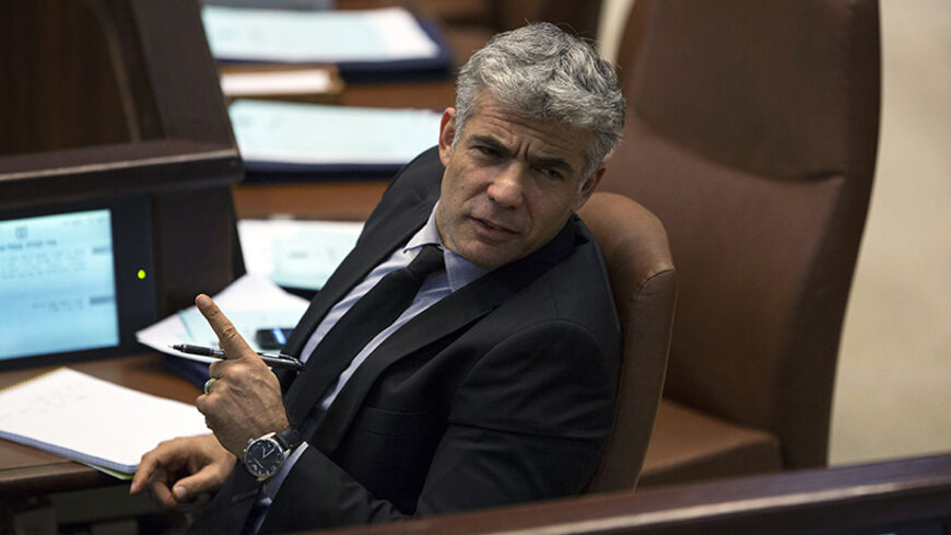 Israel's Finance Minister Yair Lapid gestures as he attends the opening of the summer session of the Knesset, the Israeli parliament, in Jerusalem April 22, 2013. Lapid is seeking spending cuts of 18 billion shekels ($5 billion) and tax increases of 5 billion shekels as part of the 2013-2014 budget framework, a spokeswoman for Lapid said on Monday. REUTERS/Baz Ratner (JERUSALEM - Tags: POLITICS BUSINESS) - RTXYVX6