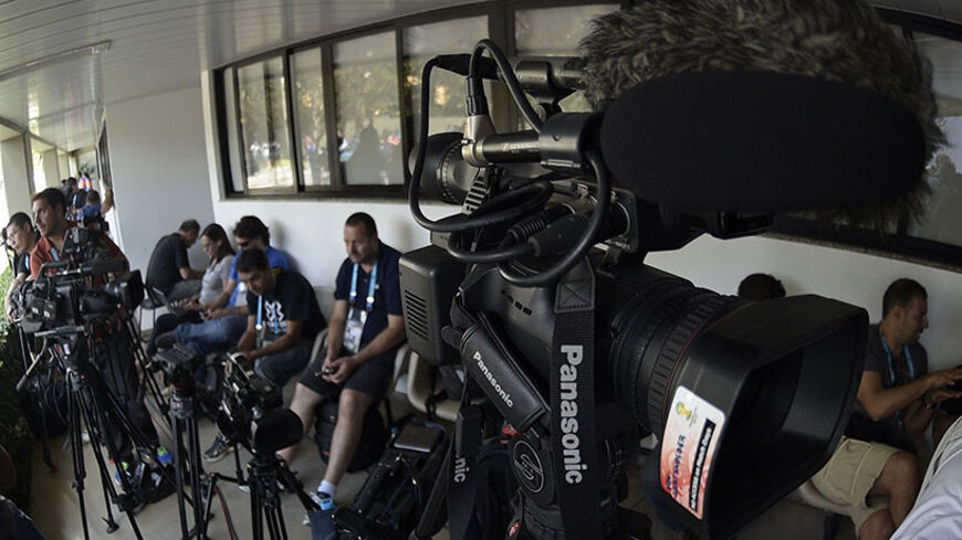 Media personnel wait to attend a press conference of Argentina's goalkeeper's Agustin Orion and Mariano Andujar at their base camp in Vespasiano, near Belo Horizonte, on June 18, 2014, ahead their 2014 FIFA World Cup Group F football match against Iran, to be held at the Mineirao Stadium in Belo Horizonte on June 21, 2014. AFP PHOTO / Juan Mabromata