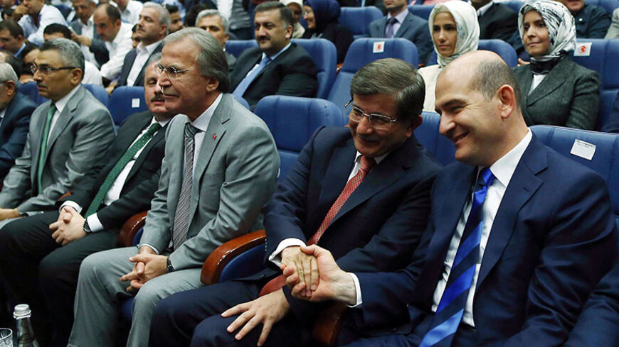 Turkish Foreign Minister Ahmet Davutoglu (2nd-R) is congratulated after being named prime minister and leader of the Justice and Development Party (AKP) during a party meeting in Ankara on August 21, 2014. Turkey's president-elect Recep Tayyip Erdogan named Davutoglu to succeed him as ruling party leader and prime minister, promoting an ally who is expected to show unstinting loyalty to the new head of state. AFP PHOTO/ADEM ALTAN        (Photo credit should read ADEM ALTAN/AFP/Getty Images)