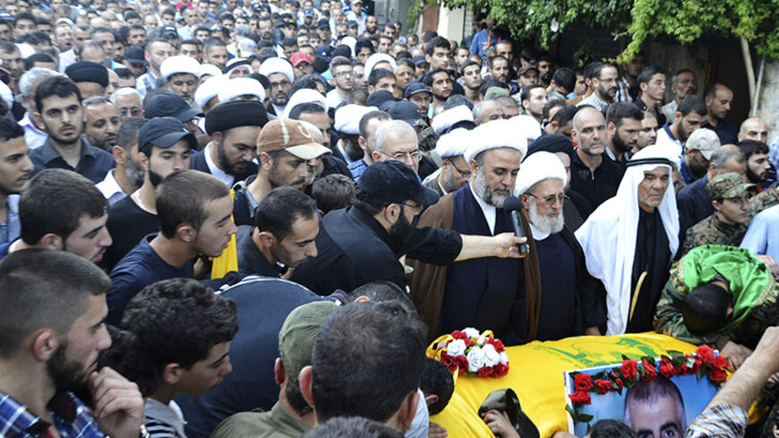 Lebanon's senior Hezbollah official Sheikh Nabil Qawouq leads the payers around the coffin of Ibrahim al-Haj, a Hezbollah commander who died during a mission in Iraq, during his funeral in Mashghara village in the Bekaa Valley July 30, 2014. A Hezbollah commander has died during a mission in Iraq, sources familiar with the incident said on Wednesday, indicating the Lebanese group that is already fighting in Syria's civil war may be involved in a second conflict in the region. Four sources in Lebanon named t
