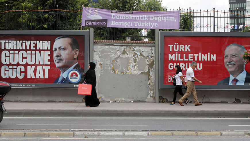 People walk past election posters for Turkey's Prime Minister and presidential candidate Tayyip Erdogan (L), Turkish main opposition presidential candidate Ekmeleddin Ihsanoglu (R) and Selahattin Demirtas, co-chairman of the pro-Kurdish Peoples' Democracy Party (HDP) and presidential candidate  in Istanbul August 8, 2014. Erdogan is set to secure his place in history as Turkey's first popularly-elected president on Sunday, but his tightening grip on power has polarised the nation, worried Western allies and
