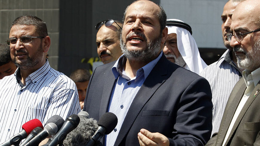 Senior Hamas leader Khalil al-Hayya (C) speaks to the media upon his return to Gaza City from truce talks in Cairo August 14, 2014. A renewed truce between Israel and Hamas appeared to be holding on Thursday despite a shaky start, after both sides agreed to give Egyptian-brokered talks more time to try to end the Gaza war. REUTERS/Ahmed Zakot (GAZA - Tags: POLITICS CIVIL UNREST) - RTR42EMW