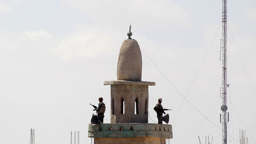 Egyptian soldiers stand guard atop a mosque's minaret in the Egyptian city of Rafah, near the border with southern Gaza Strip September 8, 2013. Egyptian security forces have destroyed at least 20 houses along the border with Gaza, local residents said, in what the Palestinian enclave's Islamist Hamas rulers fear is an effort to build a buffer zone to isolate them. REUTERS/Ibraheem Abu Mustafa (EGYPT - Tags: POLITICS MILITARY) - RTX13CMO