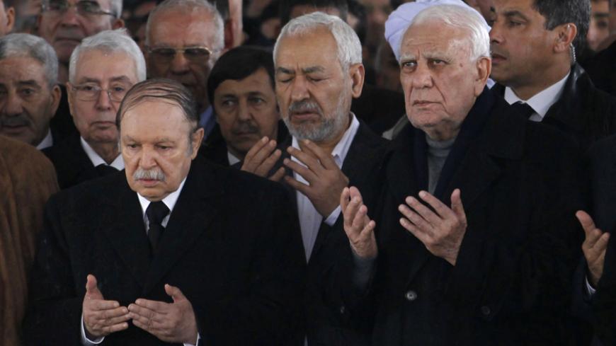 Algerian President Abdelaziz Bouteflika (L), Algerian former President Chadli Bendjedid (R) and leader of the Islamist Ennahda movement Rached Ghannouchi (C) pray during the funeral of the first President of independent Algeria Ahmed Ben Bella at Al Alia Cemetery in Algiers April 13, 2012. Ahmed Ben Bella helped lead Algeria's fight for independence from France and after victory became its first president, a figure who symbolised the romance of the national liberation struggle before the harsh reality of ru