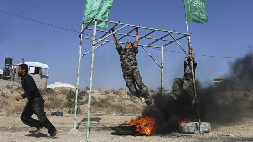 Young Palestinians take part in military-style exercise during a summer camp organized by Hamas movement in Rafah in the southern Gaza Strip June 9, 2014. REUTERS/Ibraheem Abu Mustafa (GAZA - Tags: POLITICS CIVIL UNREST MILITARY) - RTR3SX4D